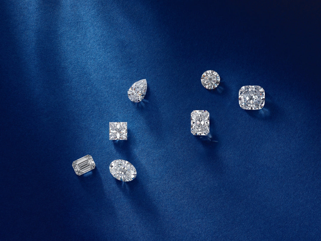 An image showing a assorted variety of diamonds in different shapes and sizes on a blue background