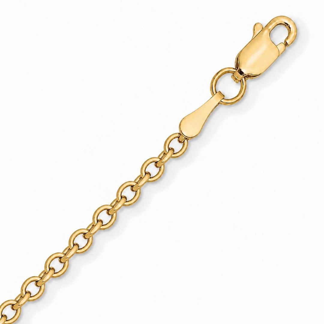 A image showing a close up of a yellow gold cable chain on a white background