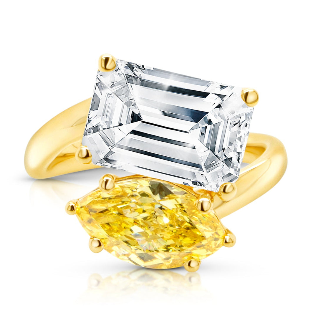 Front view of the 14 karat yellow gold two-stone engagement ring showing the fancy vivid yellow marquise lab grown diamond next to its white diamond companion on a pure white background