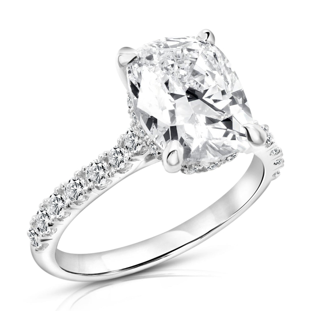 14 karat white gold 3ct elongated cushion lab grown diamond hidden halo engagement ring with diamond accent band, angled three-quarter view