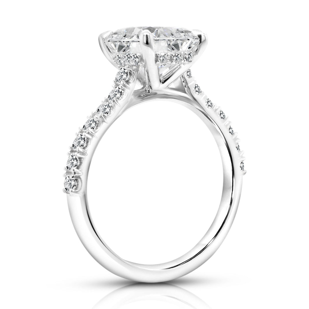 14 karat white gold 3ct elongated cushion lab grown diamond hidden halo engagement ring with diamond accent band, side profile view