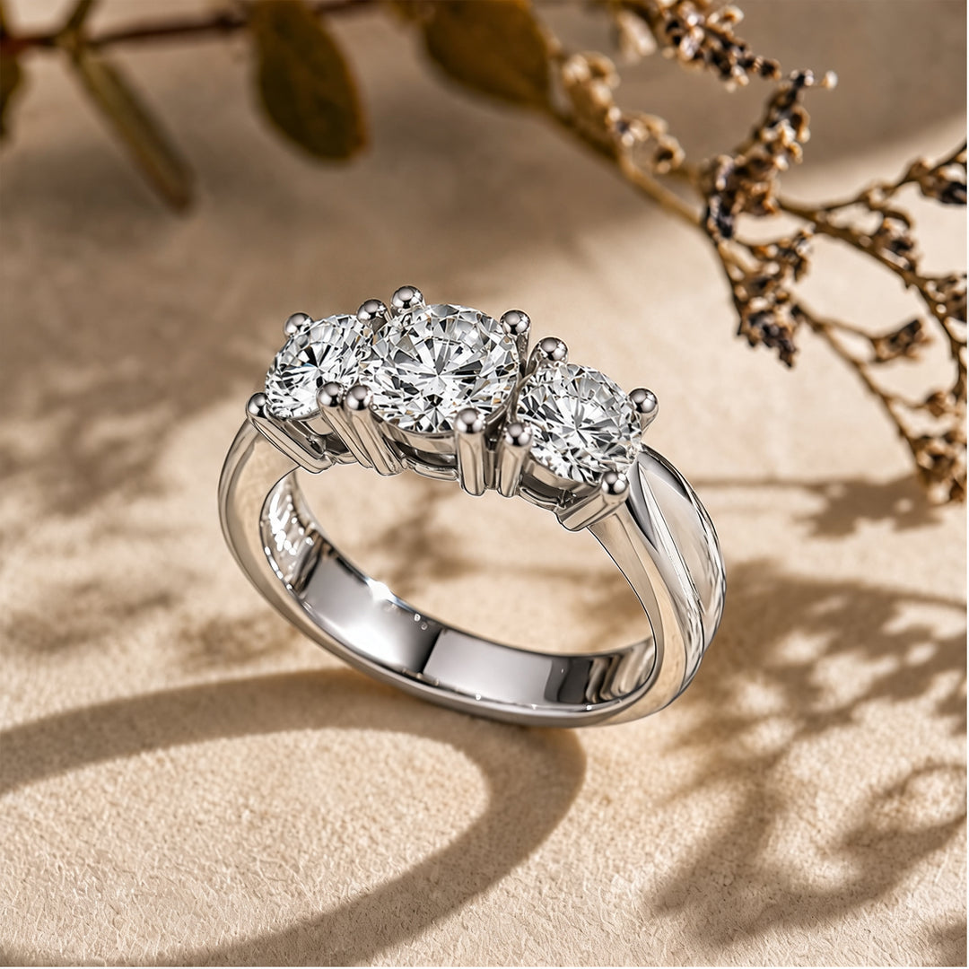 14 karat white gold lab grown diamond three-stone anniversary ring shown at an angle on a styled display at AJ's Jewelry in Ridgewood, Queens NY