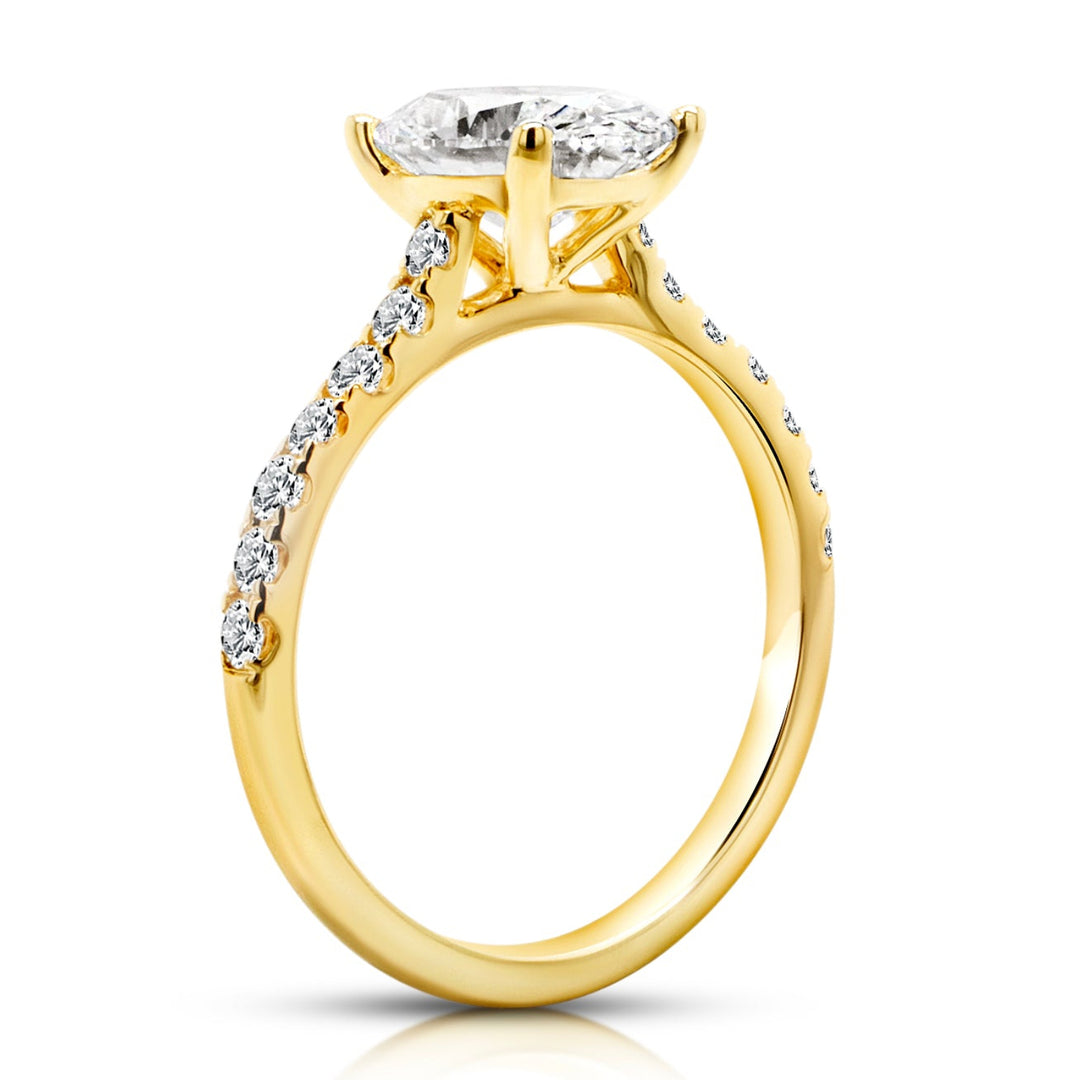 14 karat yellow gold 2ct oval lab grown diamond cathedral engagement ring with diamond accent band, side profile view