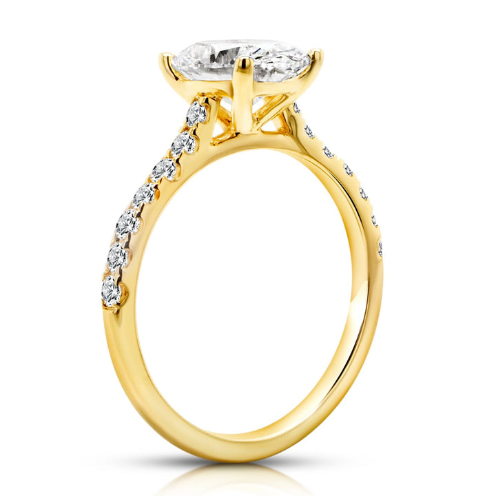 14 karat yellow gold 2ct oval lab grown diamond cathedral engagement ring with diamond accent band, side profile view