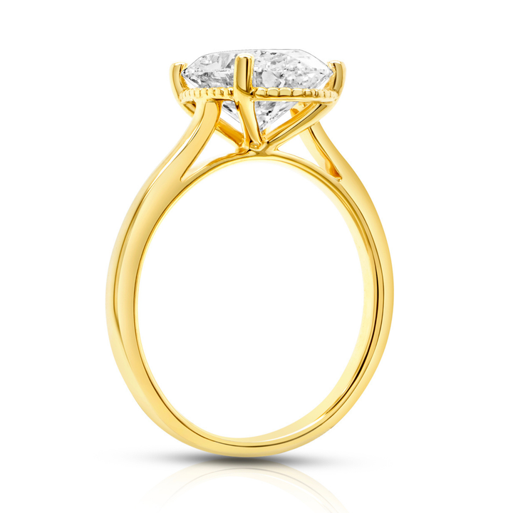 14 karat yellow gold 2ct oval lab grown diamond solitaire engagement ring, side profile showing the cathedral setting and milgrain detail