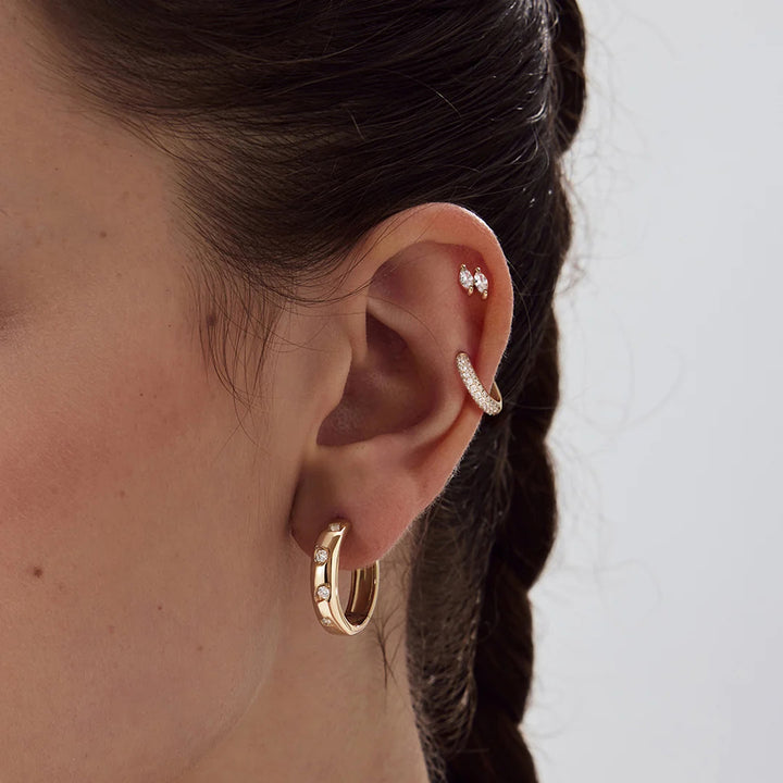 Close-up of the 14K yellow gold double marquise lab grown diamond stud earrings worn on the ear | AJ's Jewelry