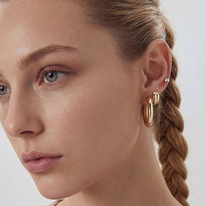 Ear stack featuring the 14K yellow gold double marquise lab grown diamond stud earrings | AJ's Jewelry