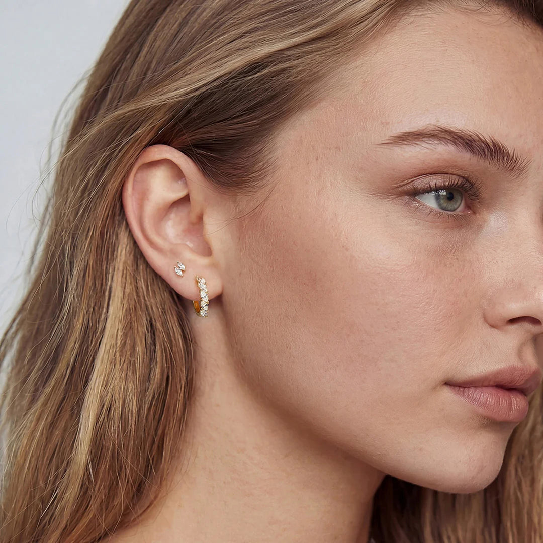 The 14K yellow gold double marquise lab grown diamond stud earrings worn on a model, three-quarter view | AJ's Jewelry