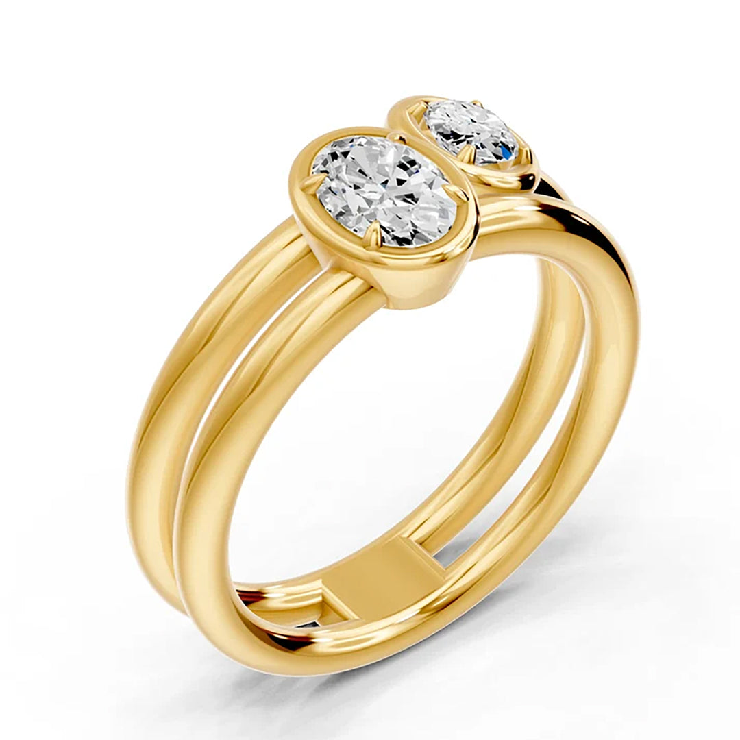 14K yellow gold two-stone ring with bezel-set lab grown diamonds on a polished double band