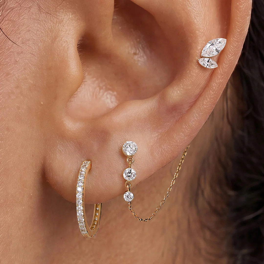 Close-up of the 14K yellow gold marquise lab grown diamond leaf flat back stud earrings worn on the ear | AJ's Jewelry