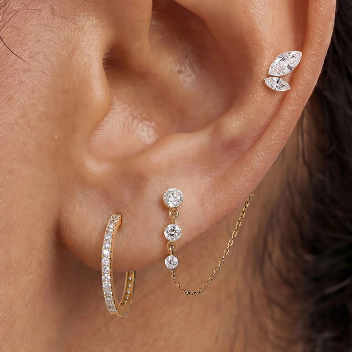 Close-up of the 14K yellow gold marquise lab grown diamond leaf flat back stud earrings worn on the ear | AJ's Jewelry