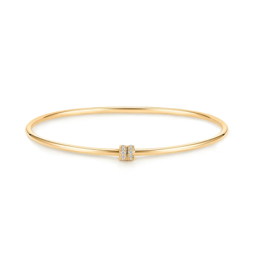 14K yellow gold bangle bracelet with a pavé-set natural diamond accent at the center