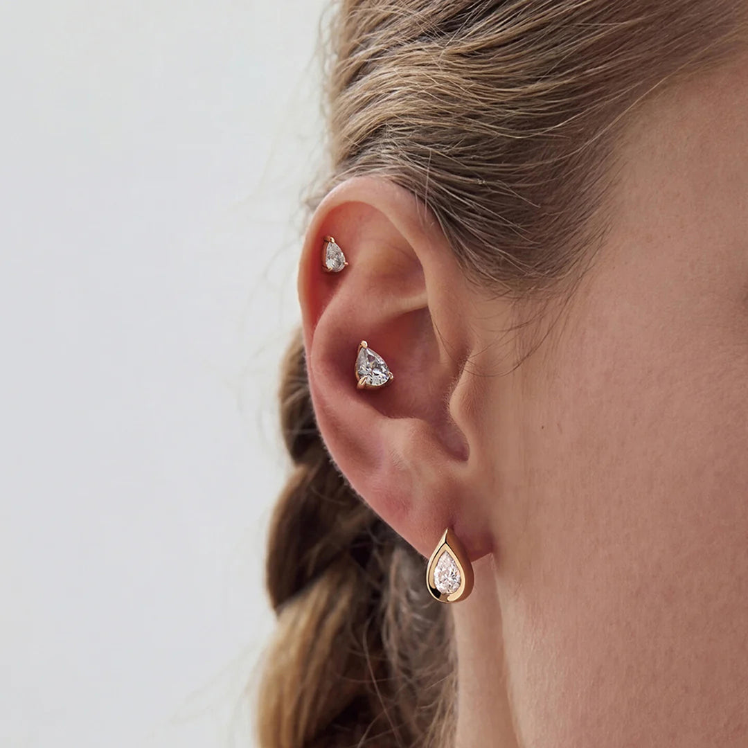 The 14K yellow gold pear lab grown diamond stud earrings worn on the ear, side view | AJ's Jewelry