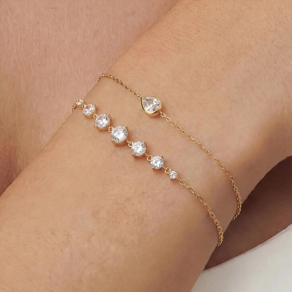 Close-up of the 14K yellow gold round lab grown diamond graduated line bracelet worn on the wrist | AJ's Jewelry