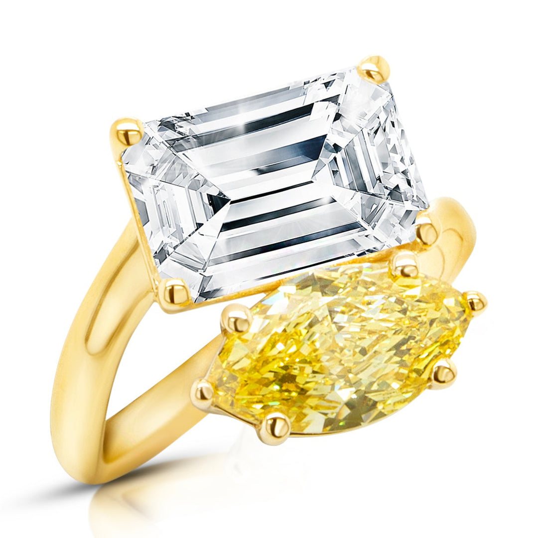 14 karat yellow gold toi et moi engagement ring with a 3ct emerald shape lab grown diamond and a fancy vivid yellow marquise lab grown diamond, angled three-quarter view