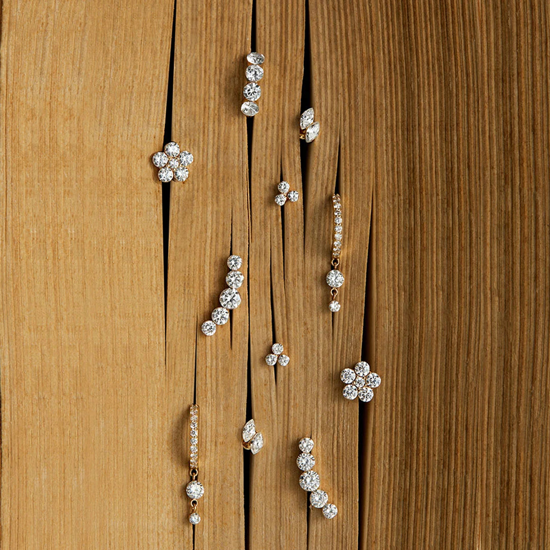 Assortment of 14K yellow gold lab grown diamond flat back stud earrings displayed on wood | AJ's Jewelry