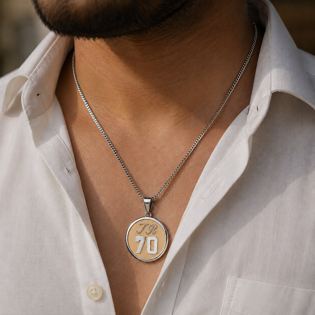 Custom 14 karat two-tone diamond TR 70 milestone birthday pendant worn on a chain with an open collar shirt