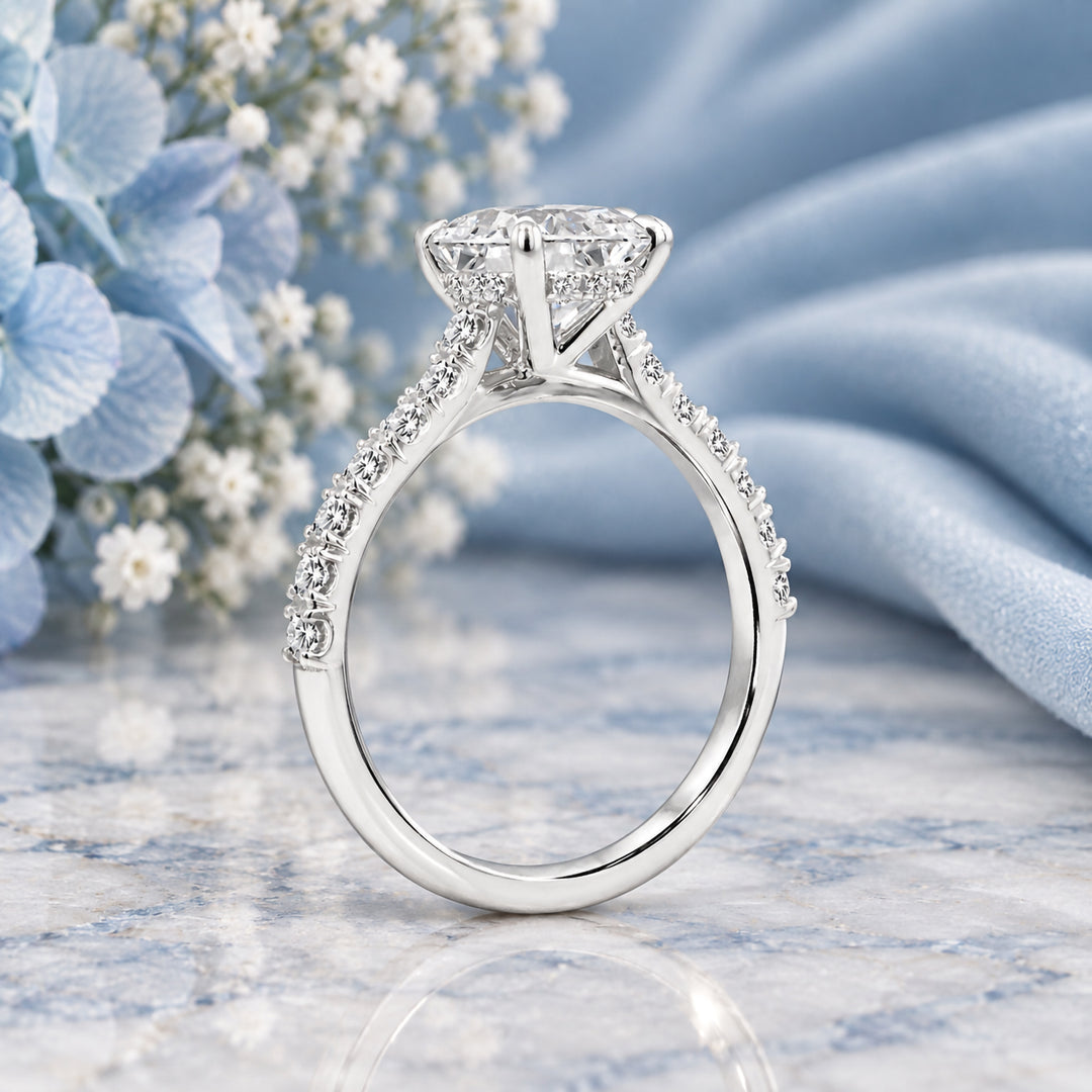 Side profile of the 14 karat white gold elongated cushion lab grown diamond hidden halo engagement ring with diamond-set band