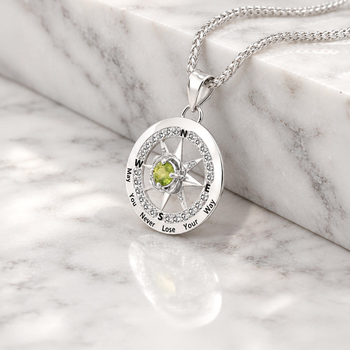 Custom 14 karat white gold birthstone compass rose pendant on a chain, made at AJ's Jewelry in Ridgewood Queens
