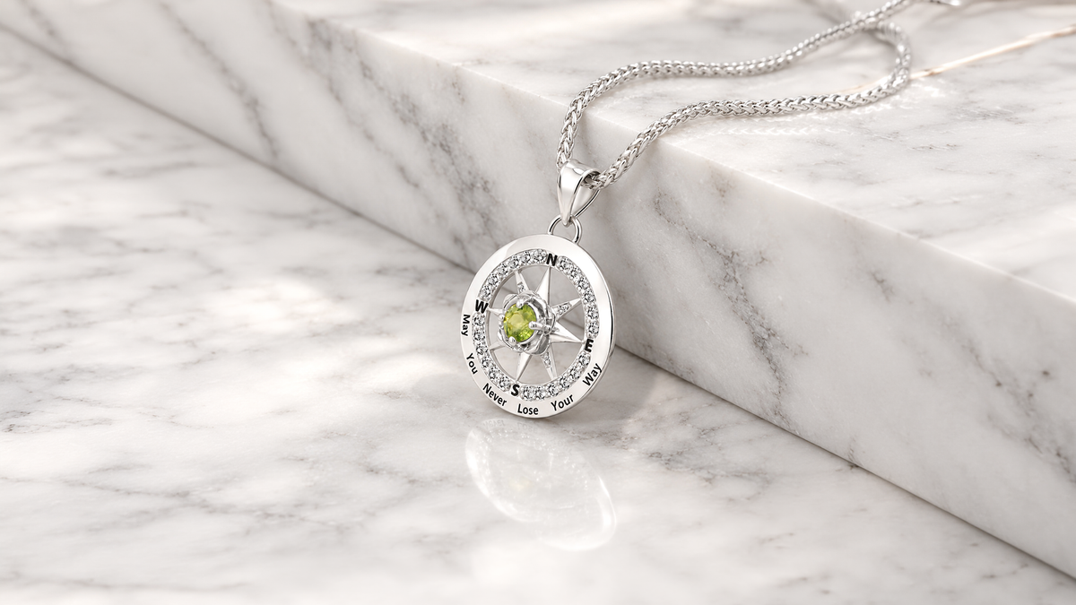 14 karat white gold compass rose pendant with natural diamonds and a peridot birthstone, custom made at AJ's Jewelry in Queens NY