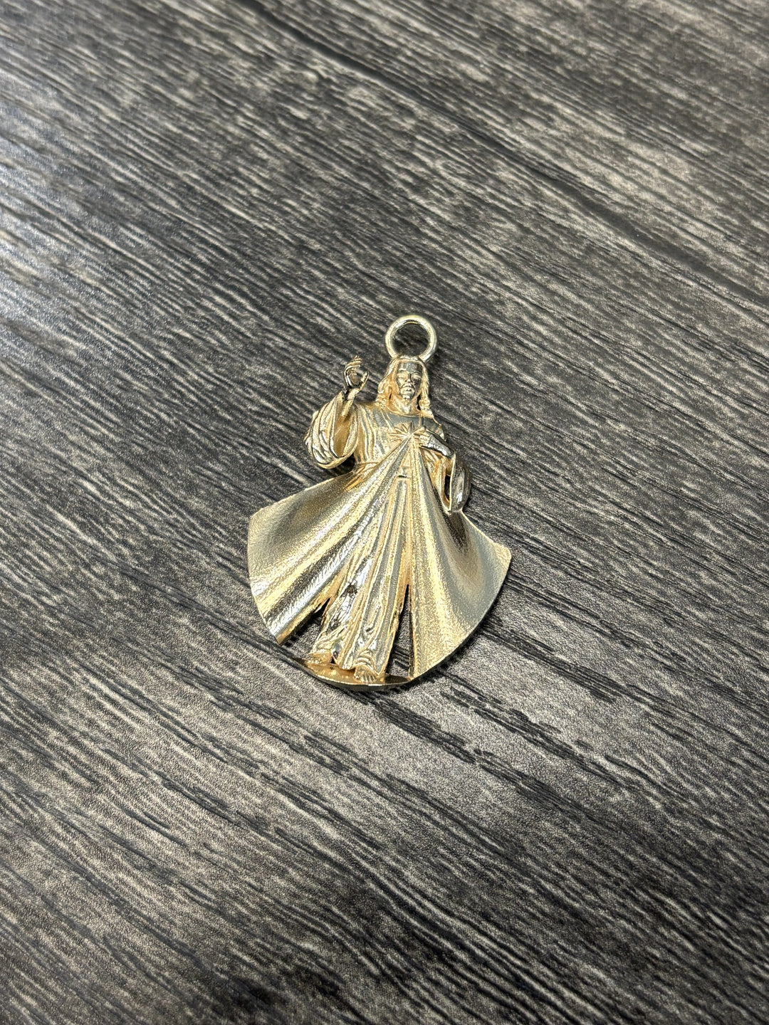 Divine Mercy pendant after tumble polishing — 14 karat yellow gold custom pendant in final finishing stage at AJ's Jewelry Queens
