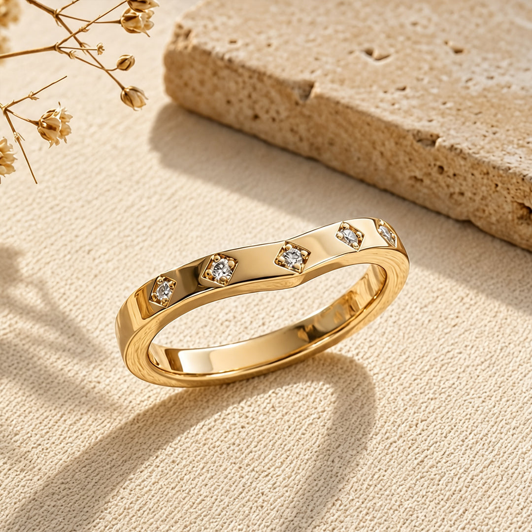 14k yellow gold lab grown diamond chevron wedding band at an angle on a styled display - AJ's Jewelry Queens NY