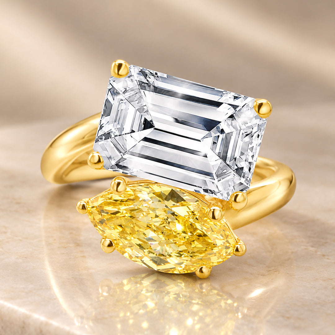 Front view of the 14 karat yellow gold two-stone engagement ring showing the fancy vivid yellow marquise lab grown diamond next to its white diamond companion
