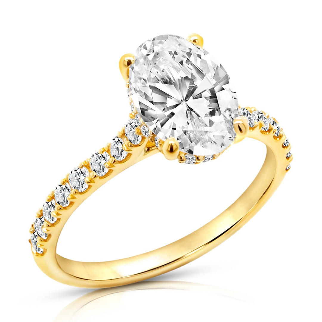 18 karat yellow gold 2ct oval lab grown diamond hidden halo engagement ring with diamond accent band, angled three-quarter view