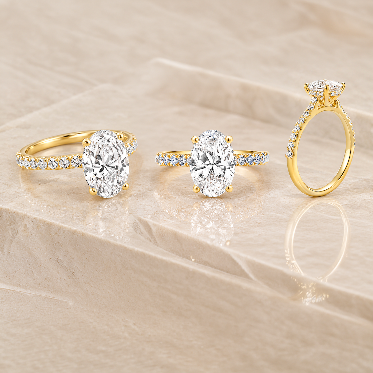 18 karat yellow gold oval lab grown diamond hidden halo engagement ring shown from three angles, custom made at AJ's Jewelry in Ridgewood Queens