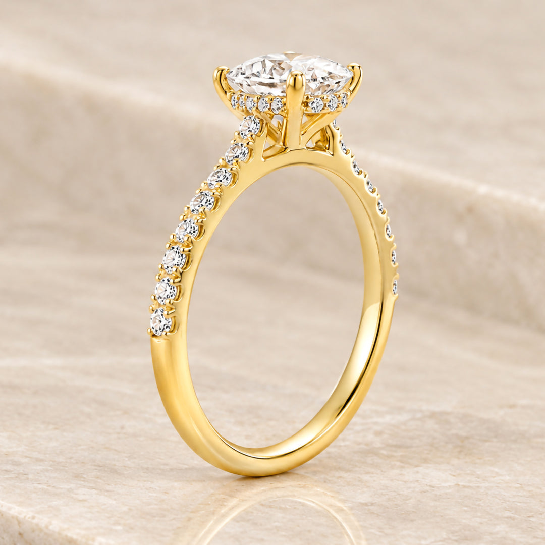 Side profile of the 18 karat yellow gold engagement ring showing the hidden halo of lab grown diamonds beneath the center stone