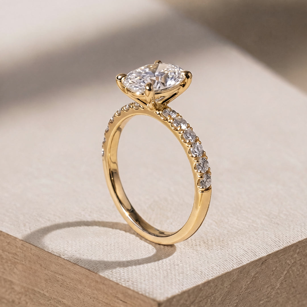 2 carat oval lab grown diamond pave engagement ring from the side on a styled display at AJ's Jewelry Queens NY