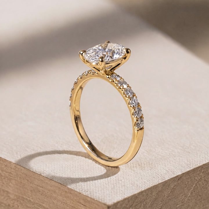 2 carat oval lab grown diamond pave engagement ring from the side on a styled display at AJ's Jewelry Queens NY