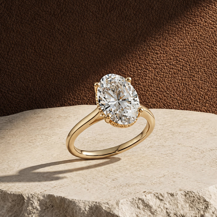 2 carat oval lab grown diamond solitaire engagement ring shown at an angle on a styled display at AJ's Jewelry in Ridgewood, Queens NY
