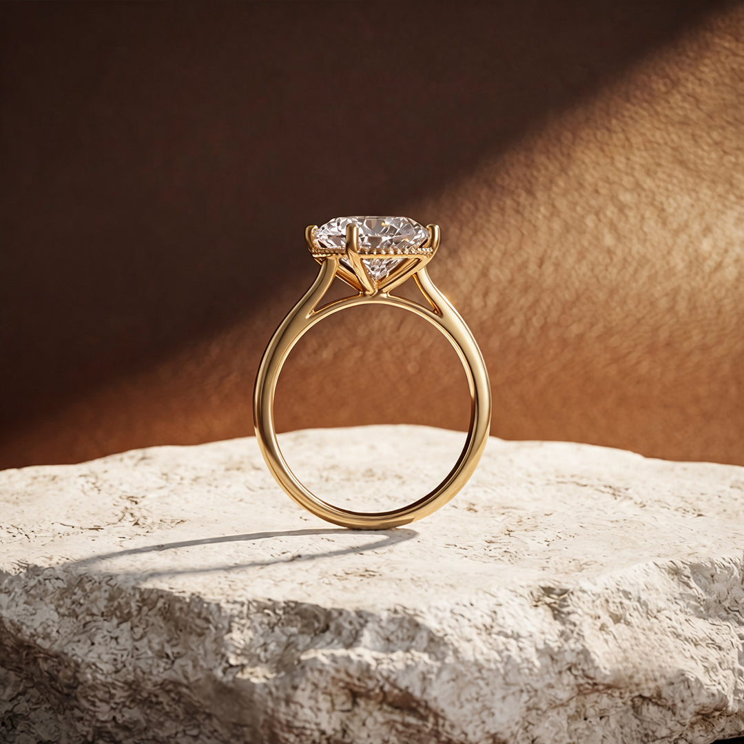 2 carat oval lab grown diamond solitaire engagement ring shown from the side on a styled display at AJ's Jewelry in Ridgewood, Queens NY