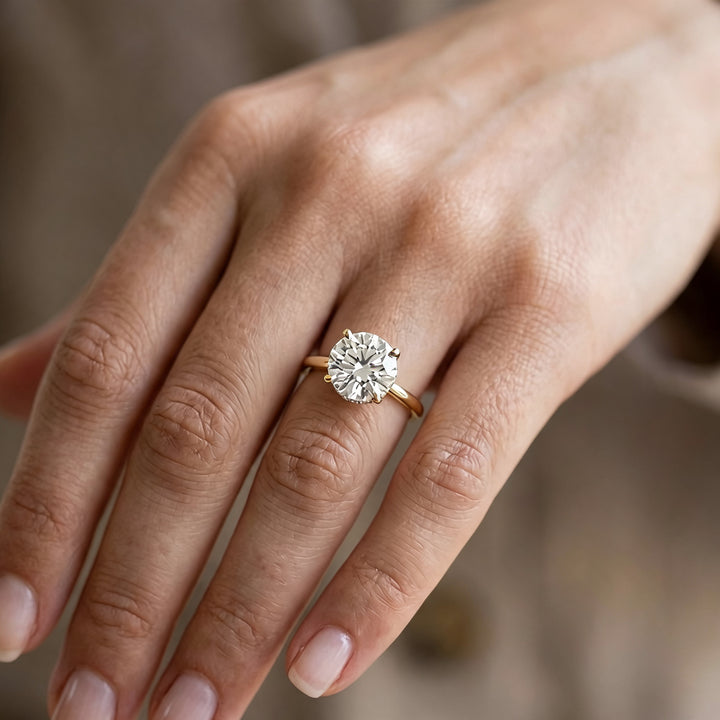 2 carat round hidden halo lab grown diamond engagement ring worn on a hand at AJ's Jewelry in Ridgewood, Queens NY