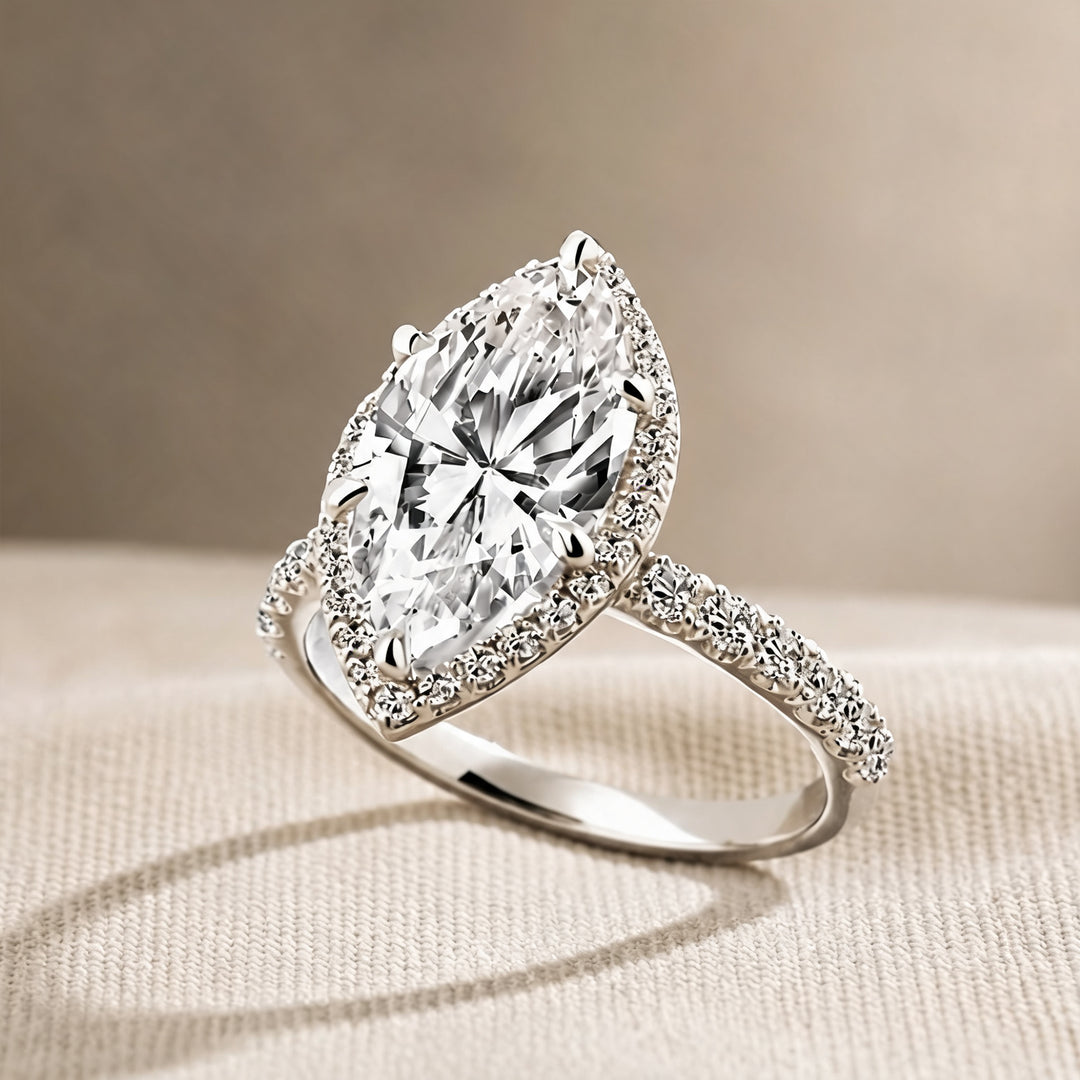 Custom 3 carat marquise lab-grown diamond halo engagement ring shown at an angle on a styled display at AJ's Jewelry in Ridgewood, Queens NY