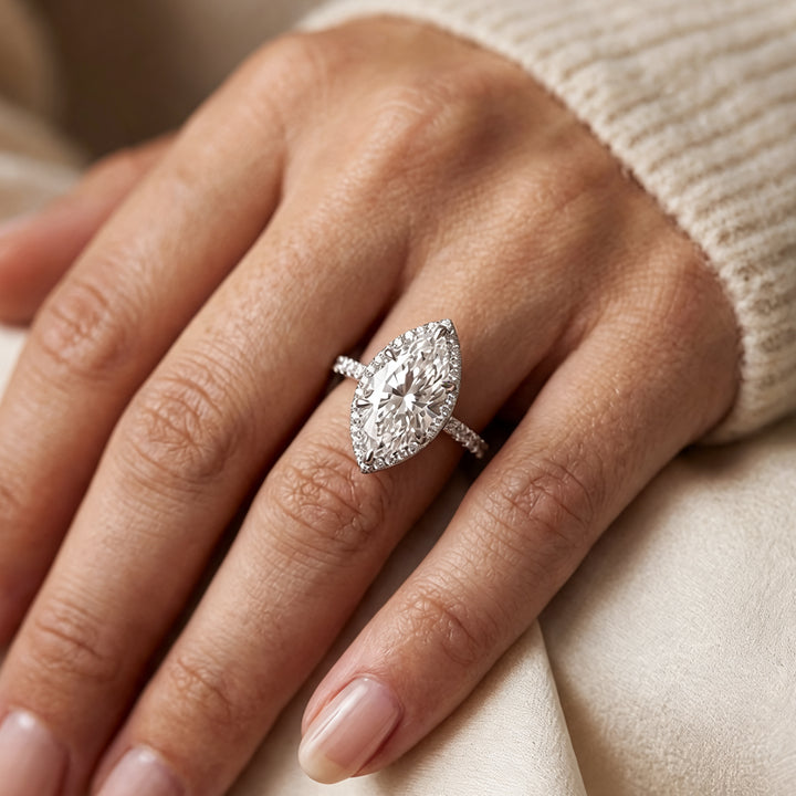Custom 3 carat marquise lab-grown diamond halo engagement ring worn on a hand at AJ's Jewelry in Ridgewood, Queens NY