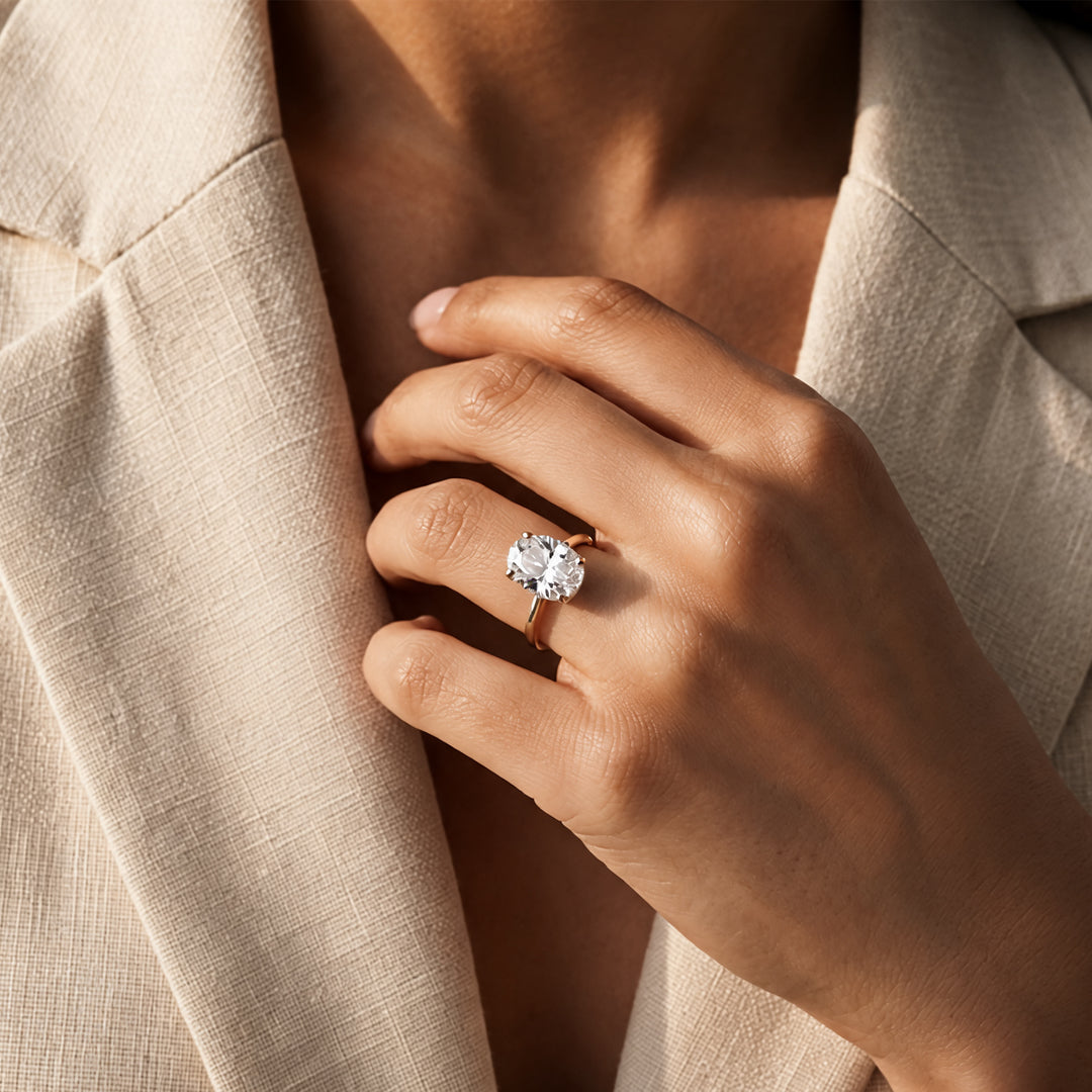 3ct oval lab grown diamond solitaire engagement ring with milgrain halo worn on a hand - AJ's Jewelry Ridgewood Queens NY