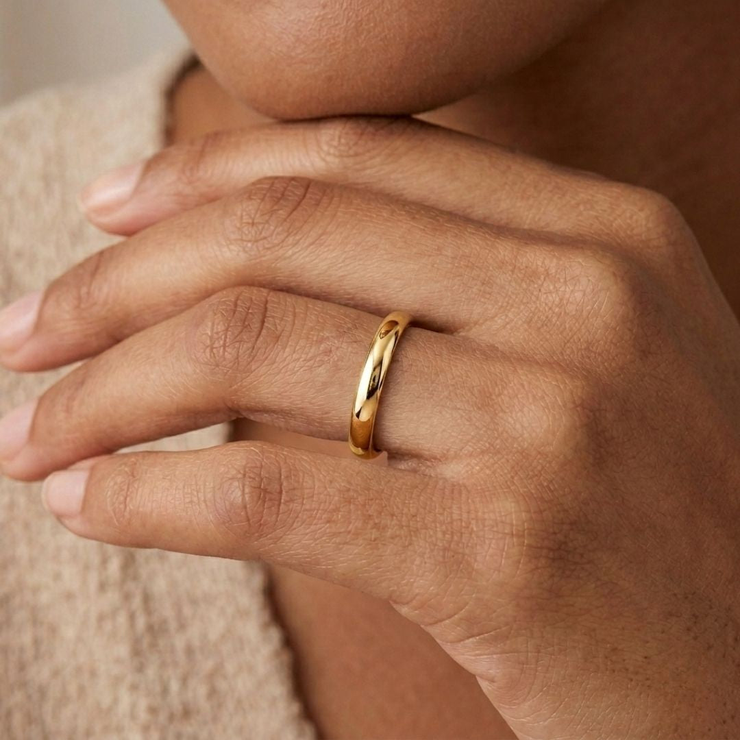A model wearing the 3mm Slim Half Round Wedding Band in Yellow Gold