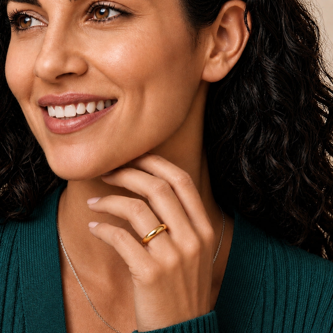 4mm 14K yellow gold comfort fit wedding band worn on a model's hand, close-up view - AJ's Jewelry, Ridgewood NY