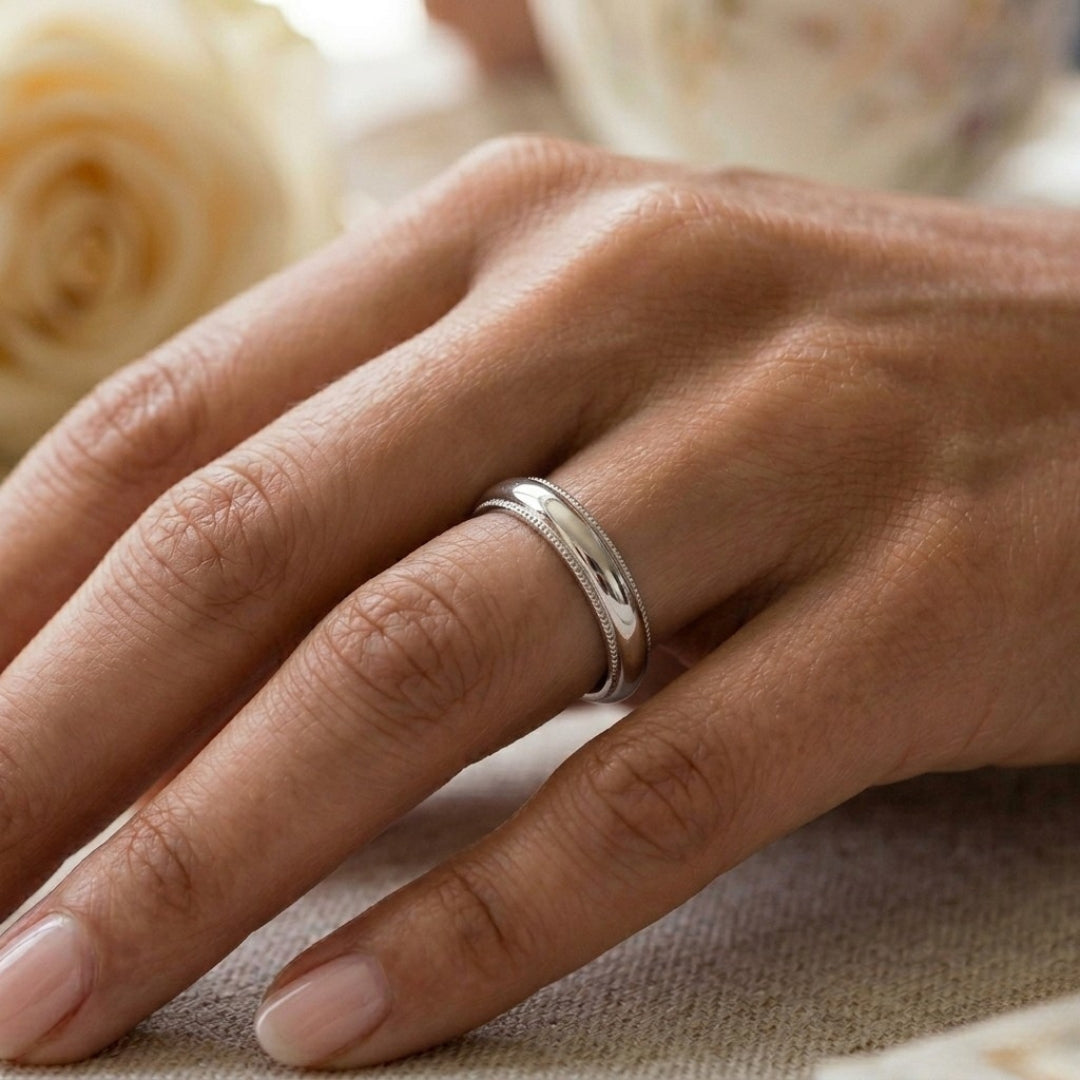 A model wearing the 4mm White Gold Comfort Fit Milgrain Wedding Band