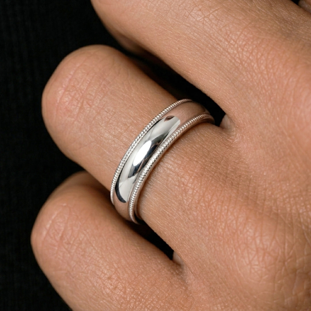 A model wearing the 5mm White Gold Comfort Fit Milgrain Wedding Band