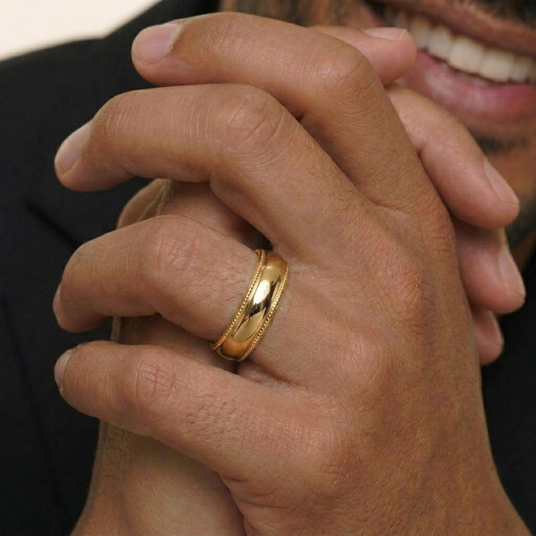 A model wearing the 6mm Yellow Gold Comfort Fit Milgrain Wedding Band