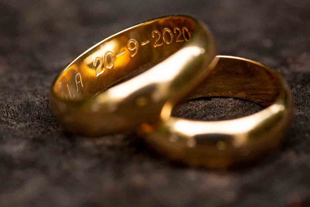 Two engraved rings sitting on a table