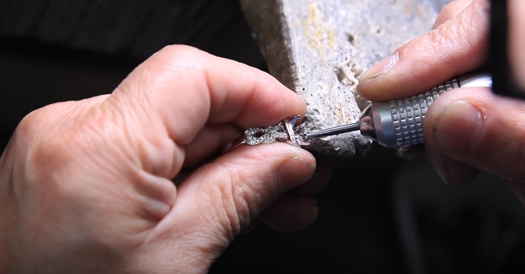 Man hand repairing a piece of jewelry