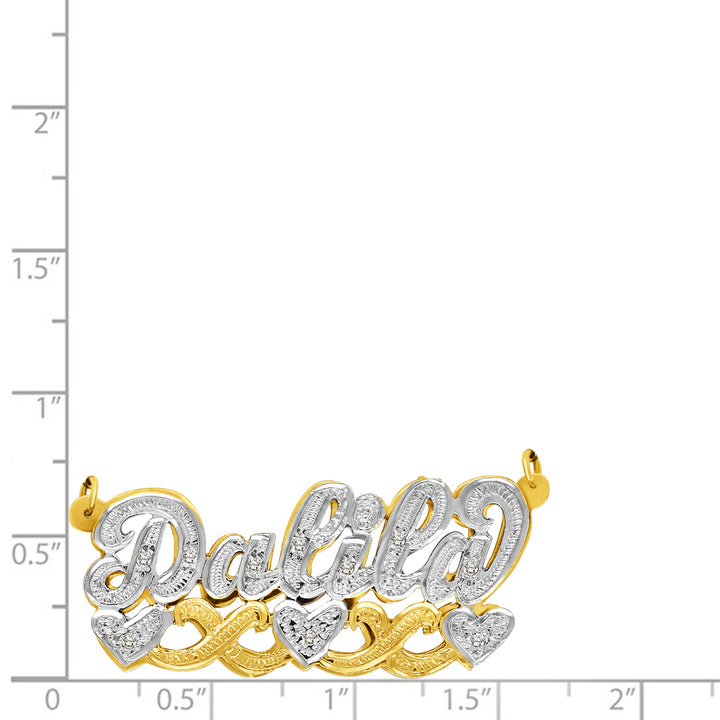 A custom script name pendant reading 'Dalila' in yellow gold and white gold, embellished with clear pavé stones and accented with three heart motifs, shown on a white background with a measurement scale.