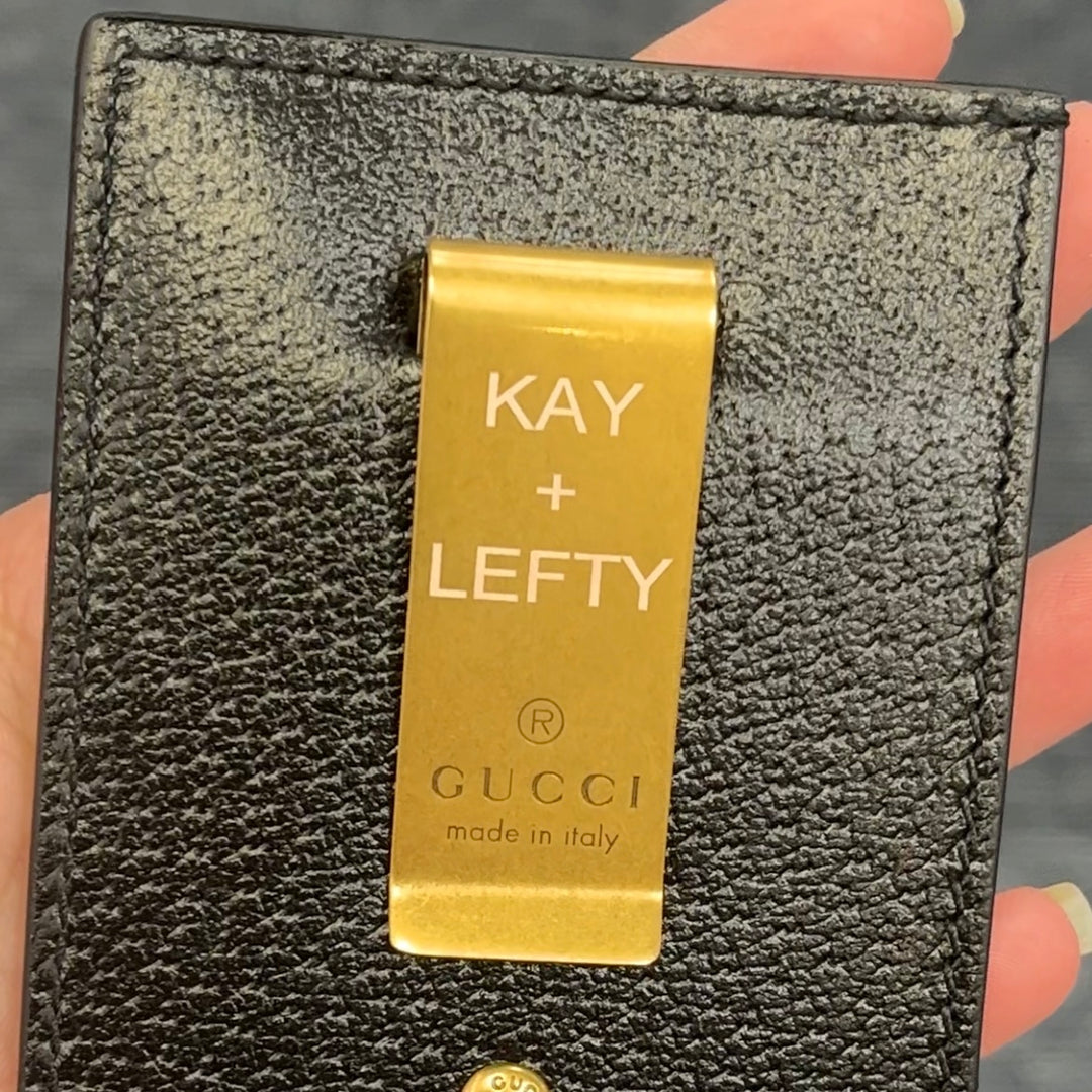 A picture showing an engraved money clip on a wallet