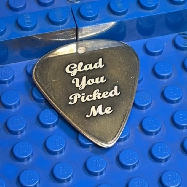 A picture showing an engraved guitar pick