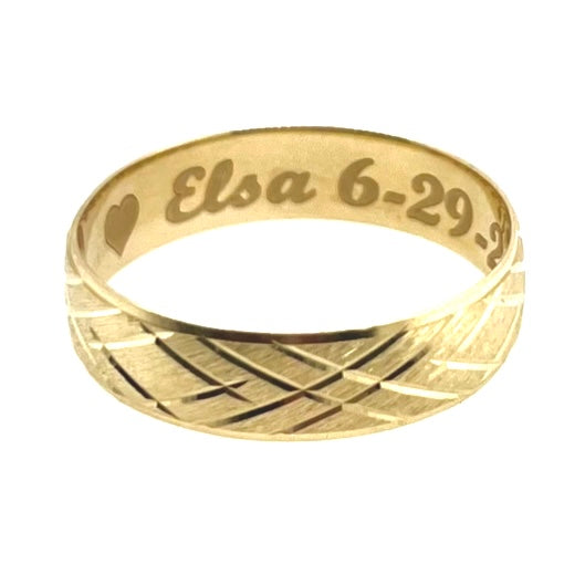 A picture showing a wedding band with an engraving on the inside