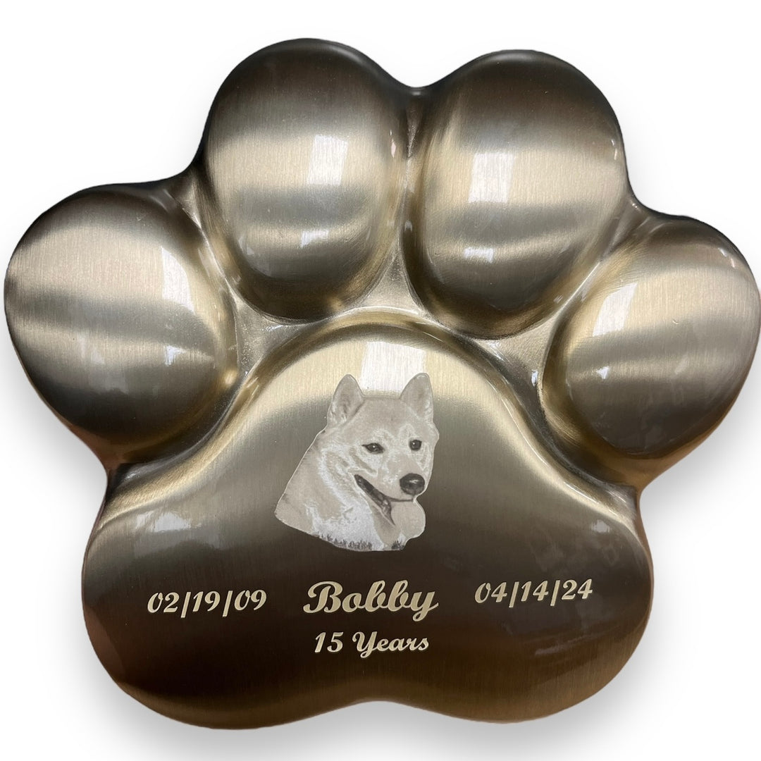 A picture showing an engraved metal pet urn